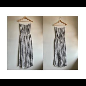 Strapless, vertical striped black and white romper with flowy pant legs